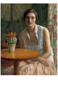 Woman seated at a table with cactus plant.