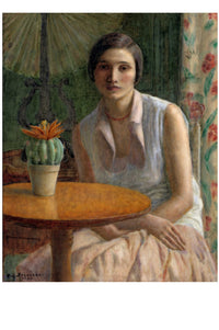 Woman seated at a table with cactus plant.
