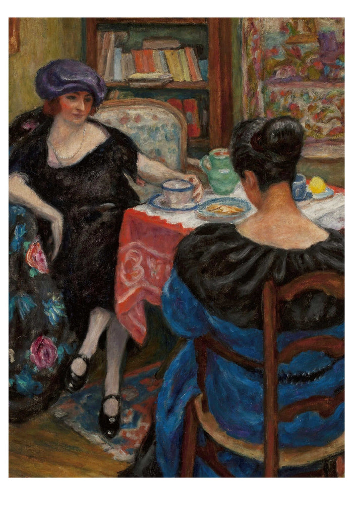 Two women at a table, with tea, in a room.