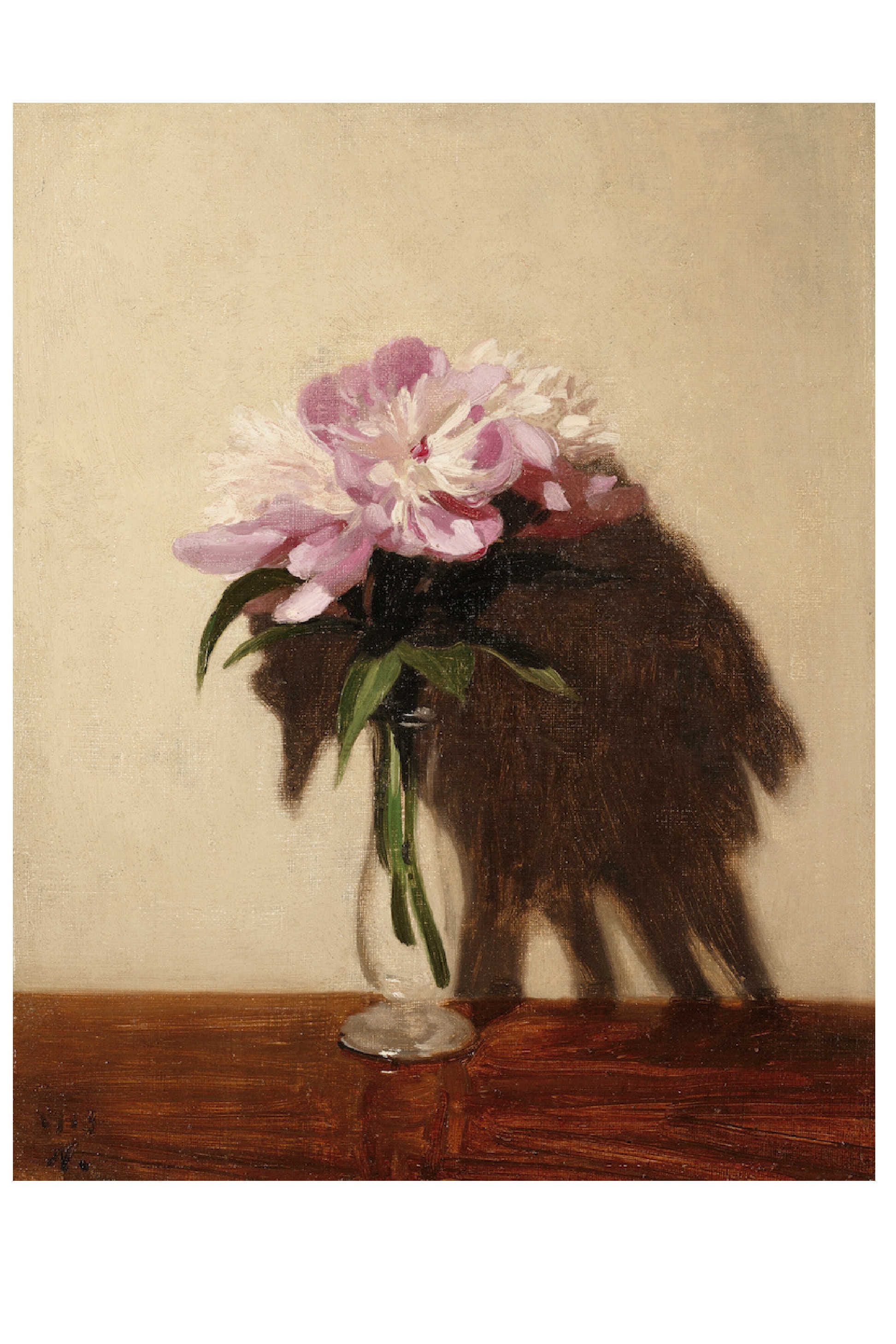 Pink peonies in a glass vase on a table.