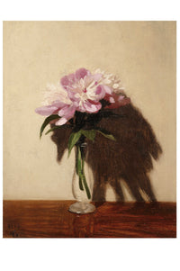 Pink peonies in a glass vase on a table.
