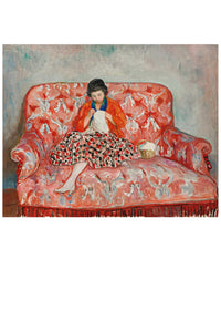 Woman knitting on a red patterned couch.
