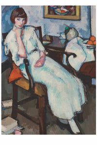 Woman in white dress seated in a chair.