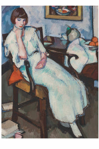 Woman in white dress seated in a chair.