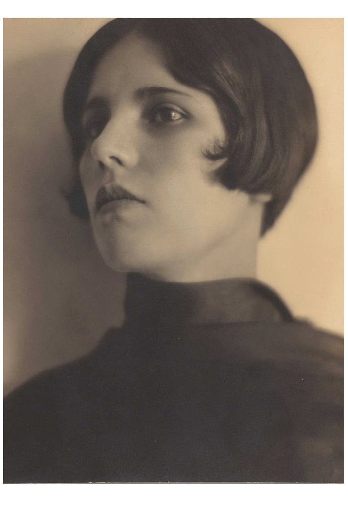 Woman with bob haircut looking off to the side.