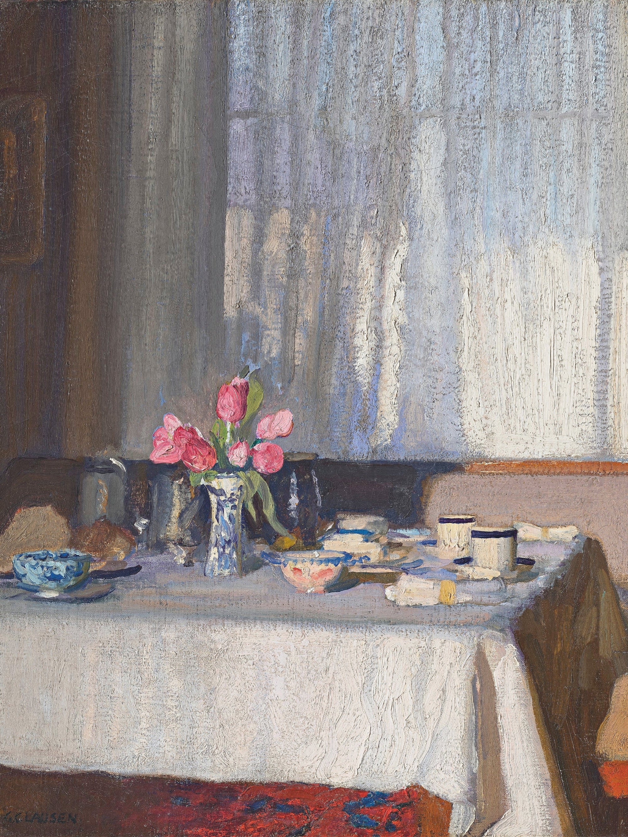 Table set for tea with flowers, cups, and a window.