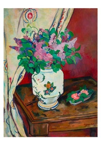 Vase of lilacs on a table
