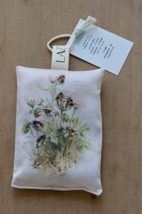 Bee sachet with bee and flower illustration, close-up