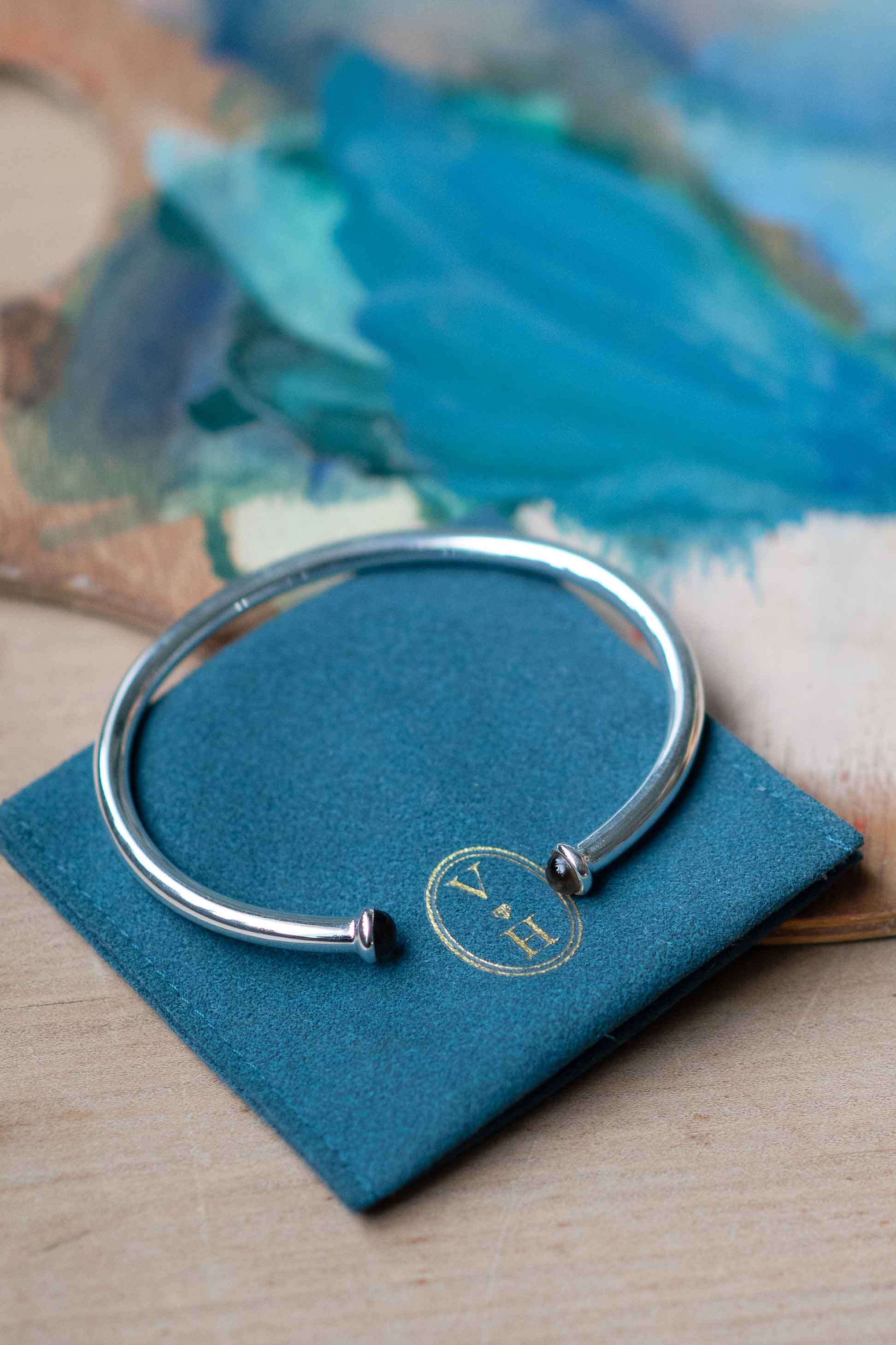 Silver bracelet on blue cloth