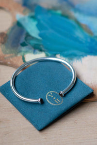 Silver bracelet on blue cloth