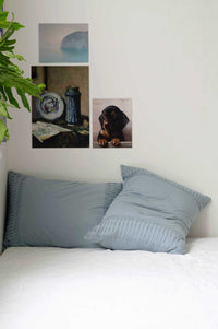 Chambray pillowcase set on bed, styled with artwork.