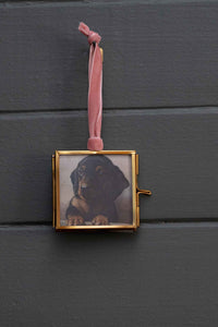 Dachshund puppy in a gold framed photo ornament