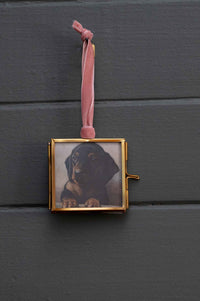 Dachshund puppy in a gold framed photo ornament