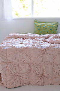 Pink tufted comforter on bed, DSC2443