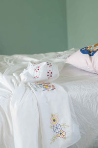 Embroidered linens on bed, DSC4622