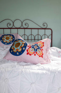 Pink decorative pillows on white bed, DSC4977