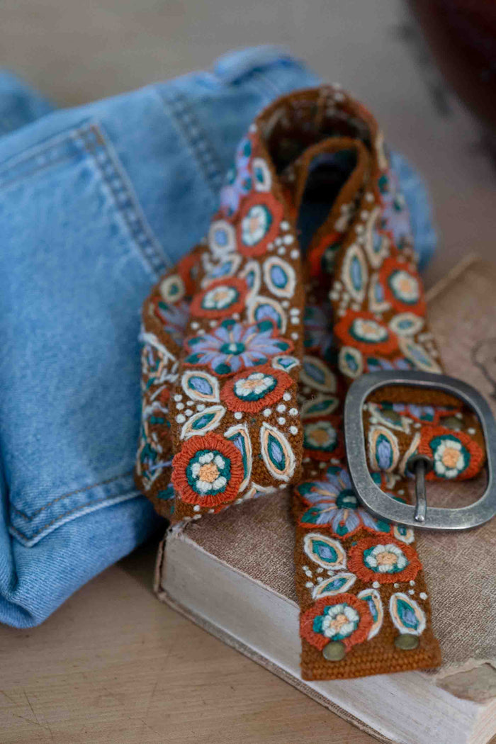 Embroidered floral belt on jeans and book - DSC5071