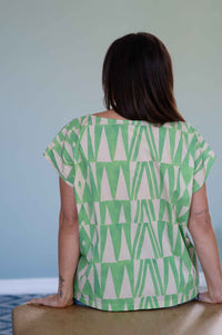 Woman wearing green triangle patterned top