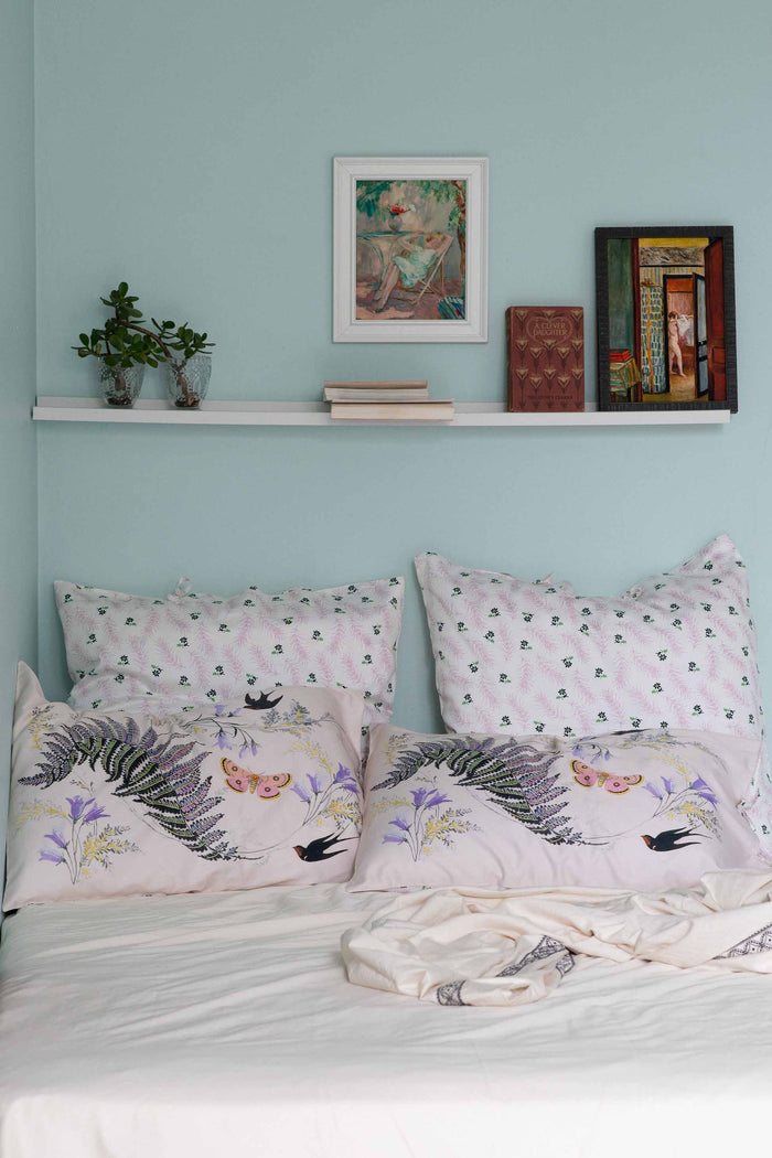 Fernly Mariette LaBelle's bedroom with artwork and decorative pillows
