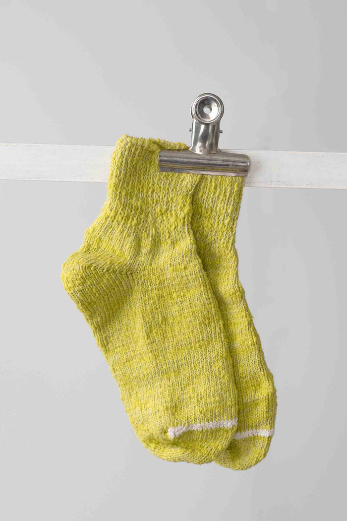 Chartreuse socks clipped on a line