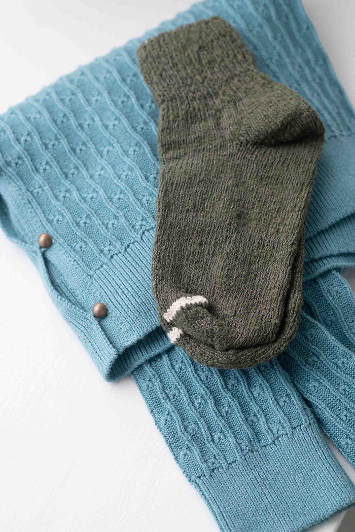 Khaki sock on blue Garabou sweater