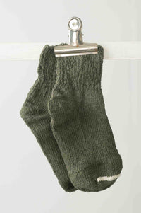 Garabou Khaki socks clipped to a line