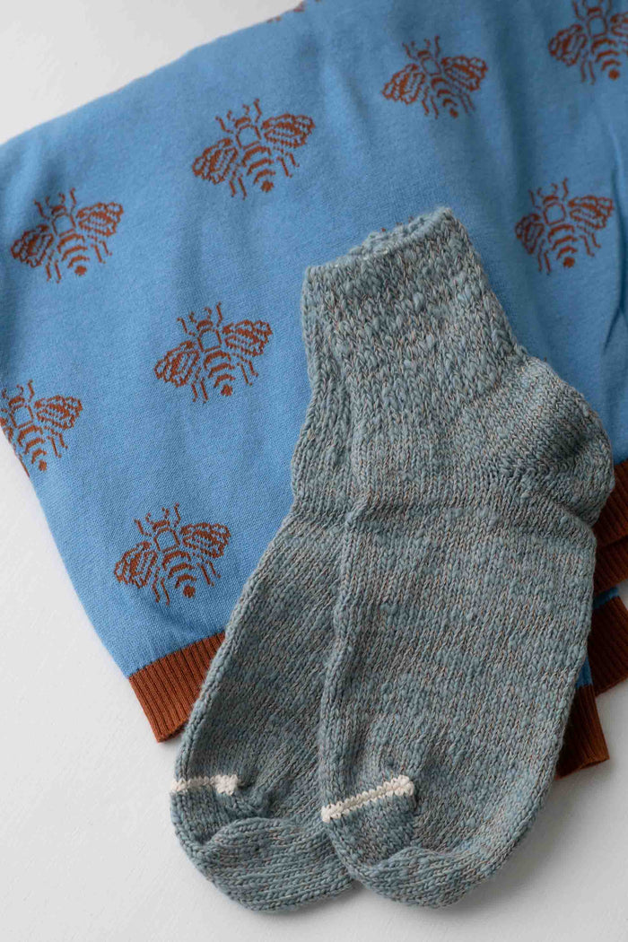 Light blue Garabou Anouk bees sweater and gray socks
