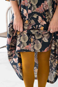 Woman wearing patterned dress and GeoOchre tights