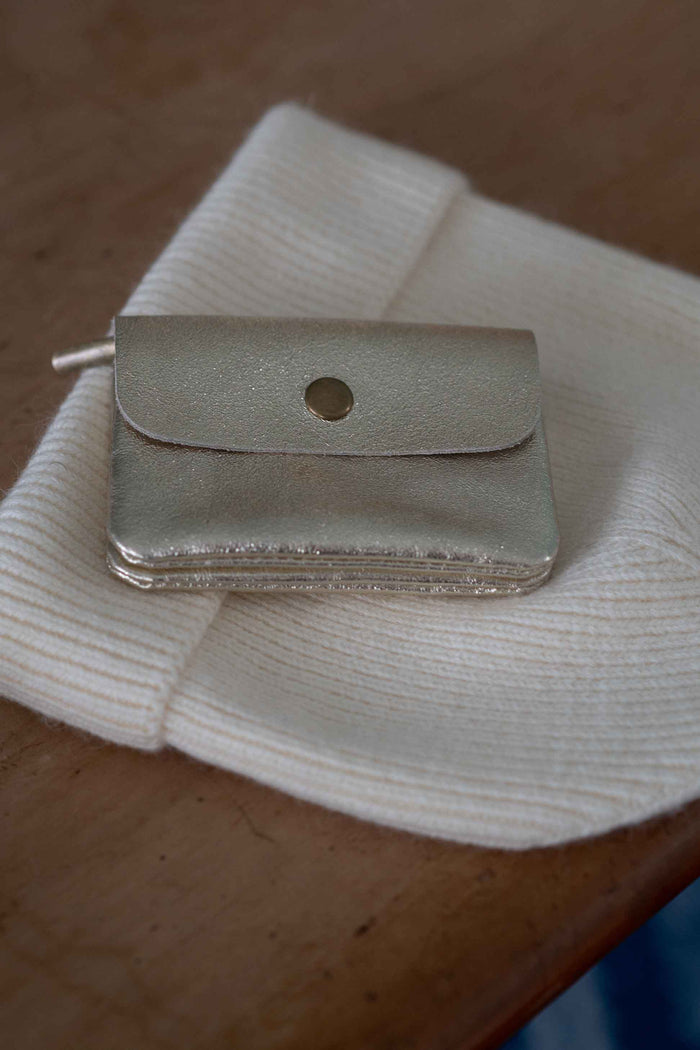 Gold purse on cream beanie