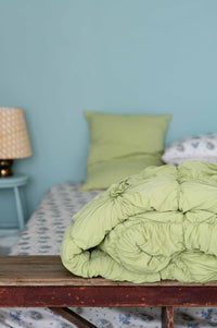 Green tea rosette bedding on a bed