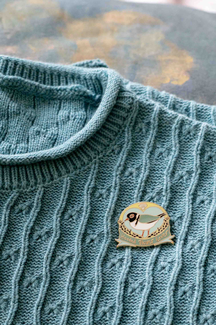 Hooded Plover pin on blue sweater