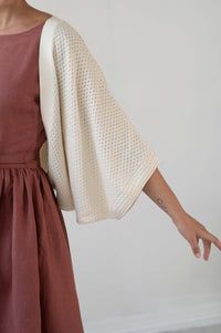 Woman in dress with off-white shrug