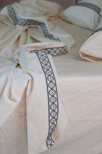 LaBelle Sheets with embroidered trim on bed
