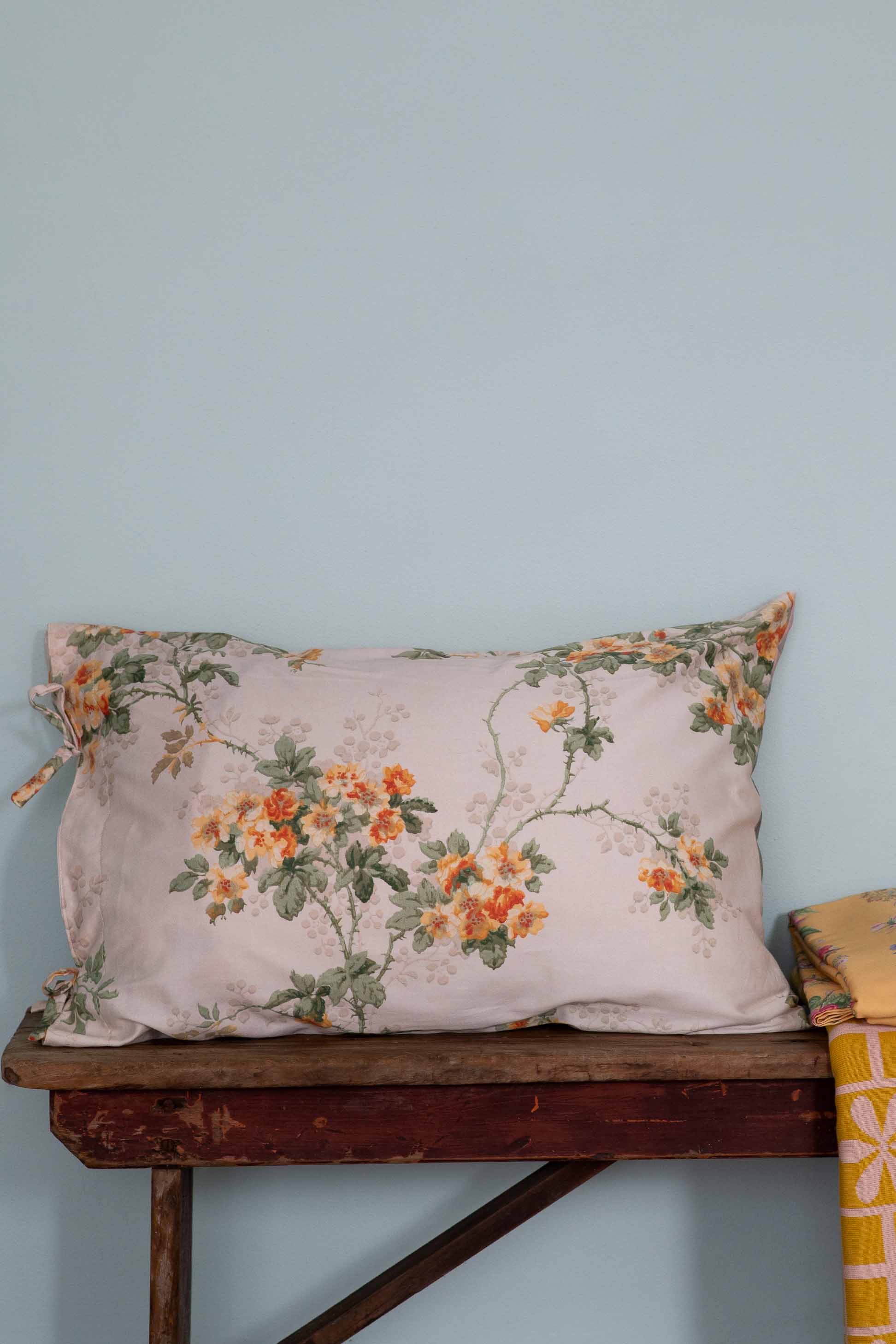 Floral pillow on wooden table