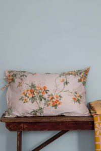 Floral pillow on wooden table