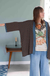 Woman in Lola cardigan with insect print shirt and denim