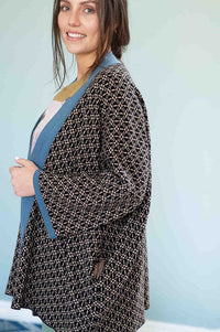 Lola Cardigan on woman, black & white pattern with blue trim