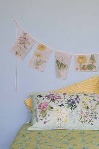 Matilda Smith Garland of floral sheets in busy garden