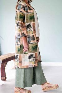 Woman in nature-print kimono and green pants.