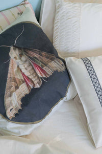Moth cushion on La Belle sheets, rosette design, natural textiles.