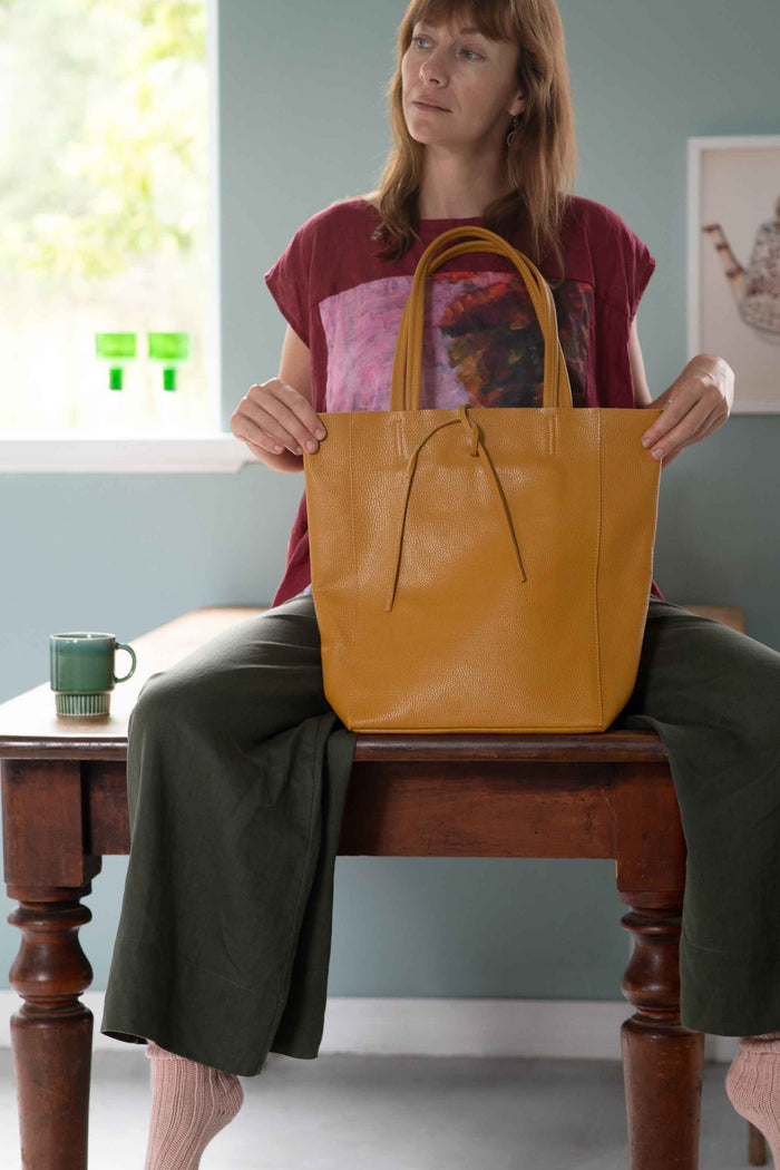 Woman with mustard bag and Ollie Thyme still life
