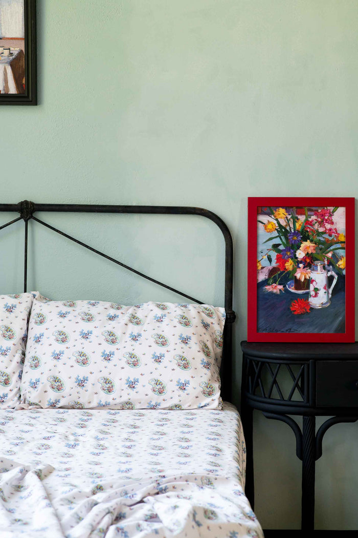 Art print of flowers on bed with floral sheets