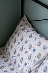 Paisley print pillow on bed