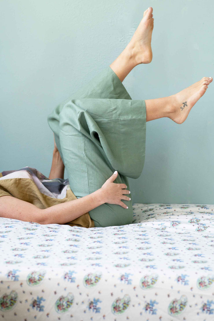 Peggy in green pants doing a pose in Ollie & Sage's garden.
