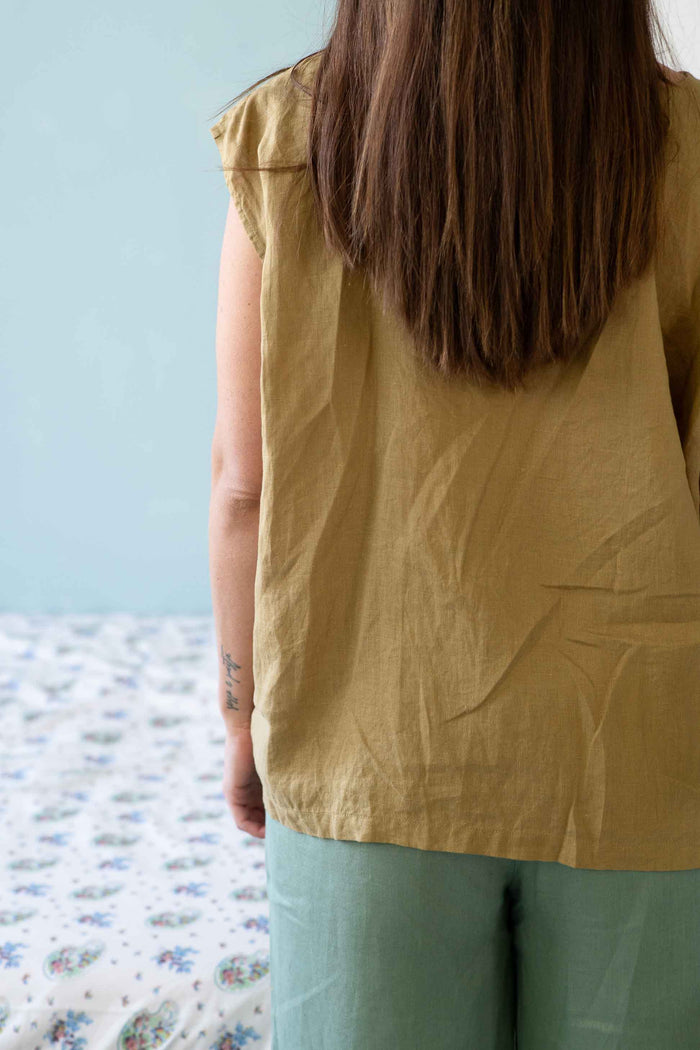 woman in linen top and green pants