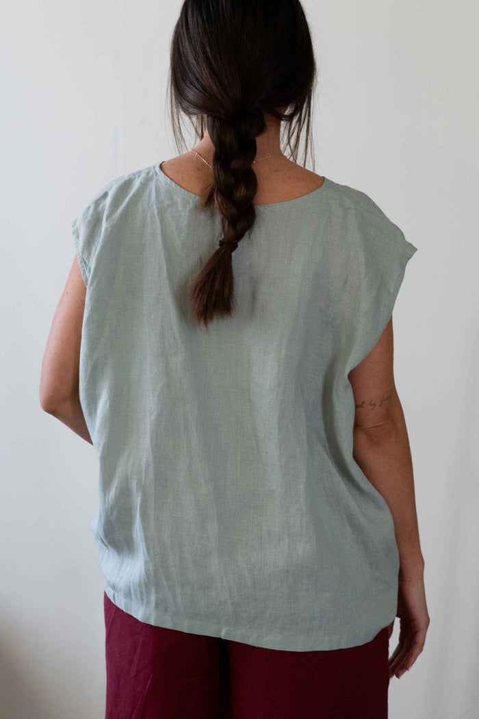 Woman in green top and red pants, Peggy StillLife Ollie Red