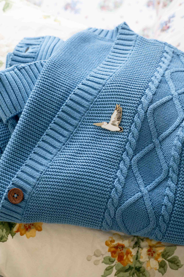 Blue cardigan with pelican pin