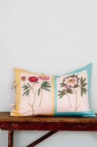 Peonies pillow with floral design on wooden table