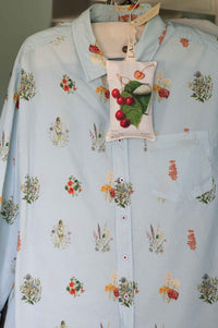 Prunus scented sachet on light blue floral shirt