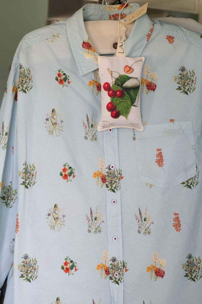 Prunus scented sachet on light blue floral shirt